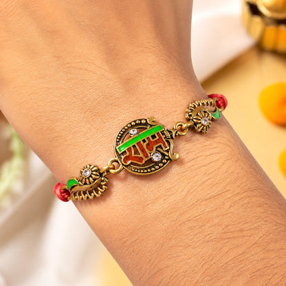 Antique Gold-Toned Ram Rakhi with Crystal Accents, Green Enamel & Designer Red Thread