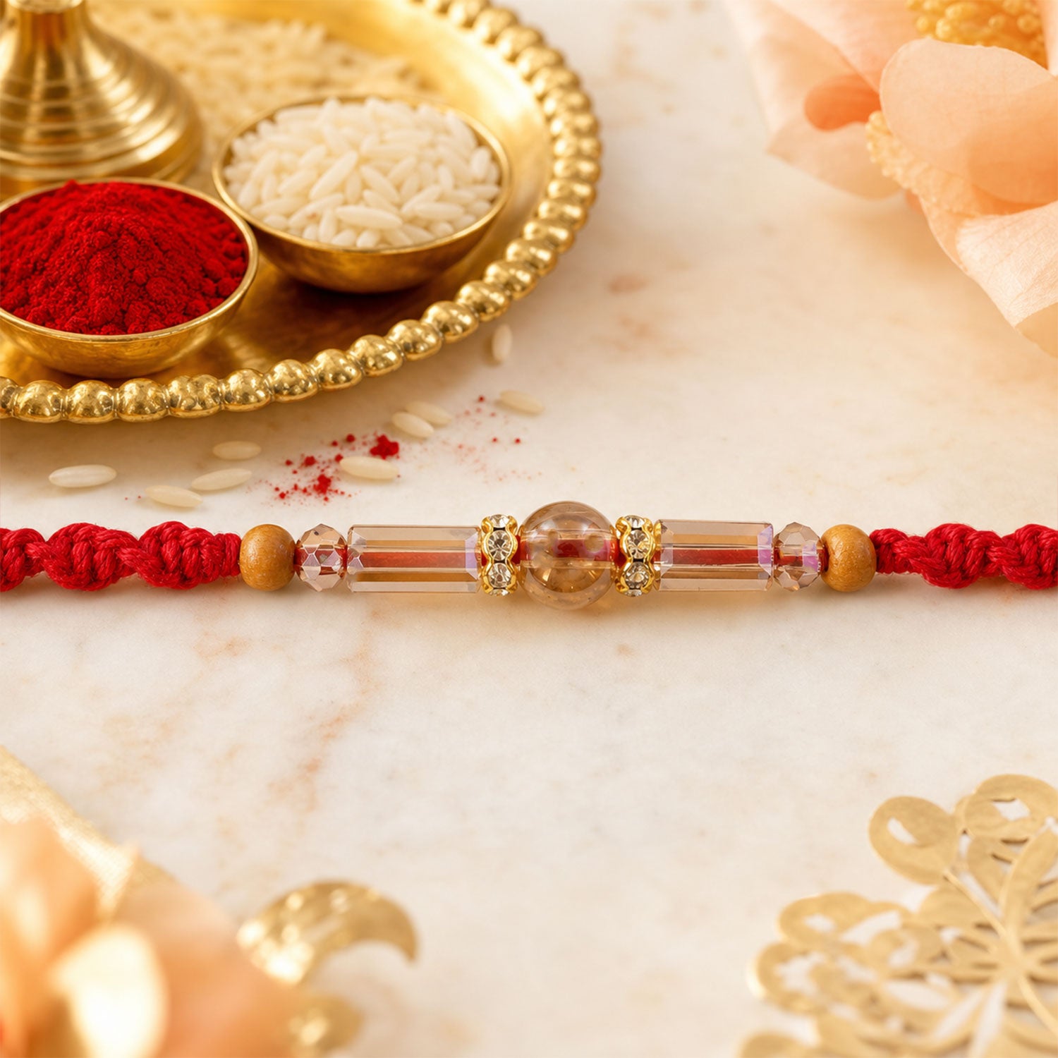 Red Braided Rakhi with Wooden Beads and a Pink Crystal Cylinder Bead