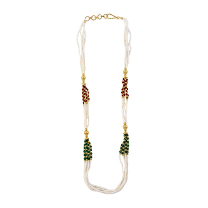 Detailed view of gold-toned elements on white beads