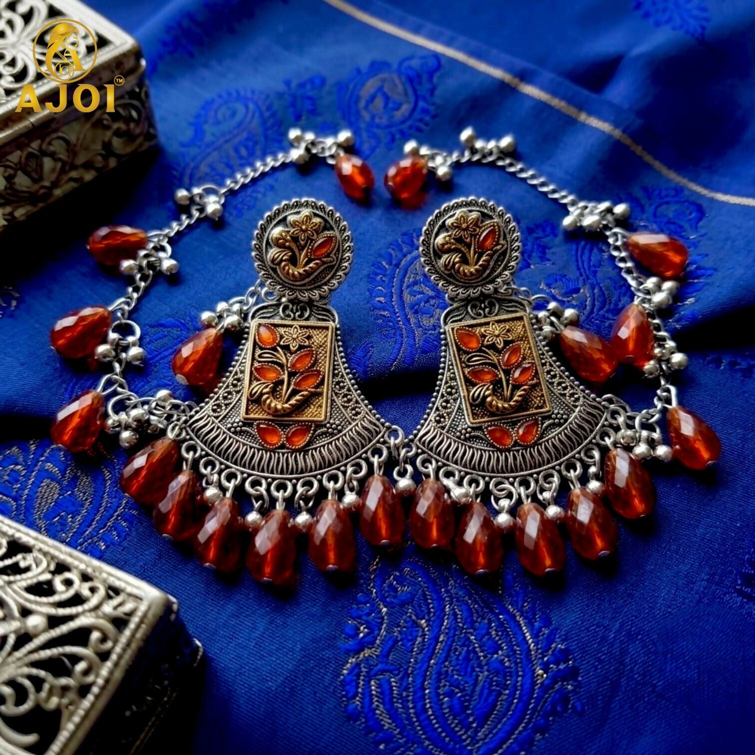 Side view of two-tone oxidised floral earring with intricate details