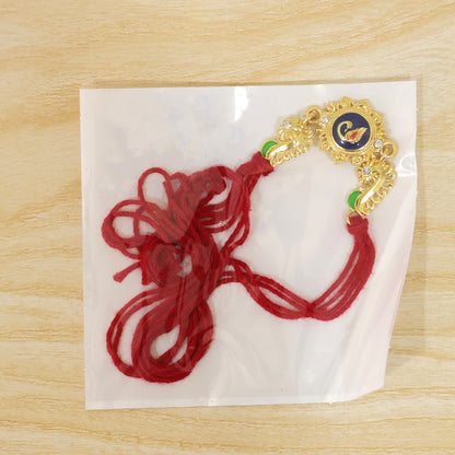 Ornate Rakhi showcasing Blue Oval Medallion, metal trims and chain look for Gift Use