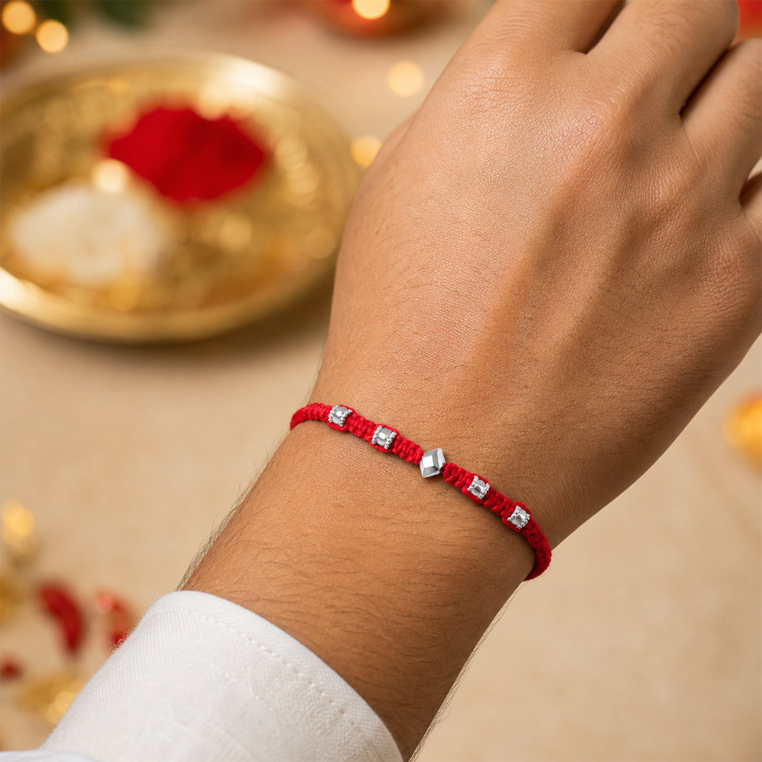 Red Thread Rakhi with Silver Square Beads and Diamond-Shaped Charm