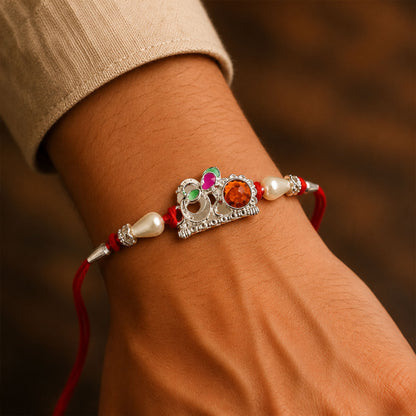 Red Gold Floral Om Rakhi with White Pearls and Orange Stone Center