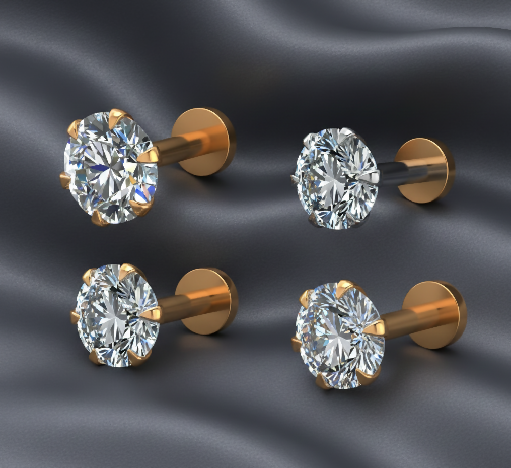 Close-up view of gold plated flat back stud earrings with clear crystals