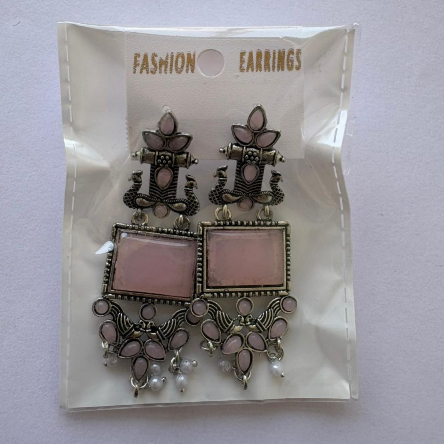 Pair of oxidized silver pink stone pearl drop earrings displayed on a white background for ethnic wear