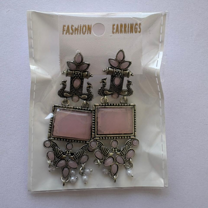 Pair of oxidized silver pink stone pearl drop earrings displayed on a white background for ethnic wear