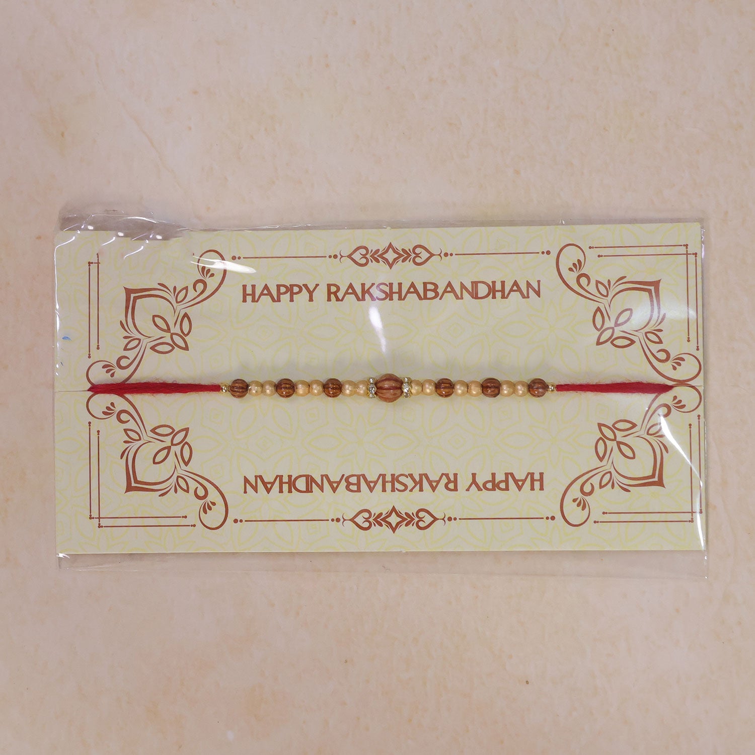 Red Thread Rakhi with Wooden Bead Pendant and Golden Bead Accents