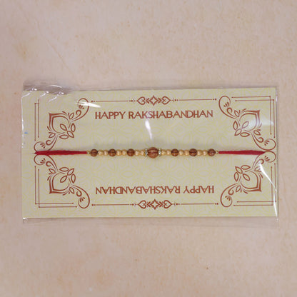 Red Thread Rakhi with Wooden Bead Pendant and Golden Bead Accents