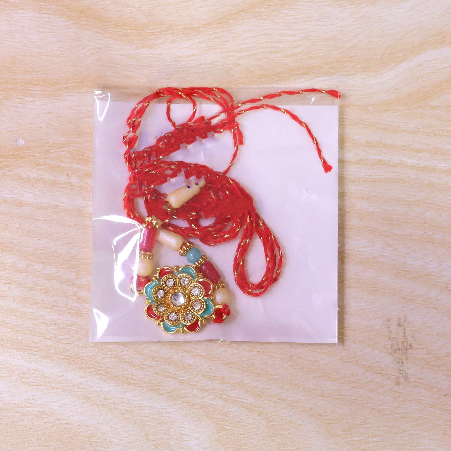 Festive Rakhi with Floral Rosette and crystal accents in bead line for Raksha Bandhan