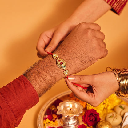 Sacred Bond Designer Gold Rakhi with Ruby & Emerald Stone