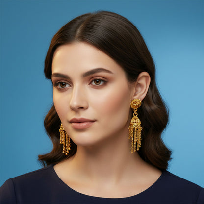 Side angle of gold plated tassel jhumka earrings