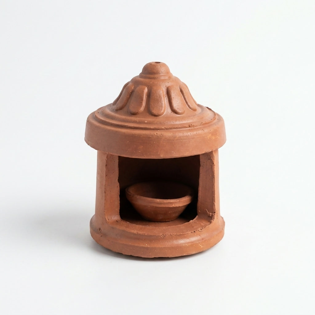 Close-up of petal engravings on diya lamp's protective cover