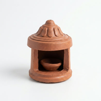 Close-up of petal engravings on diya lamp's protective cover