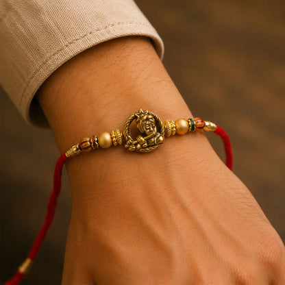 Kanha Krishna Name Devotional Rakhi with Golden Flute Detail and Red Thread