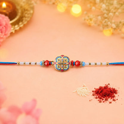 Colorful Kundan Round Rakhi with Red Beads and Blue Thread Edges