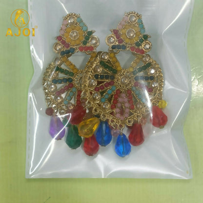 A pair of vibrant gold earrings with colorful beads and teardrop drops are sealed inside a clear plastic bag.