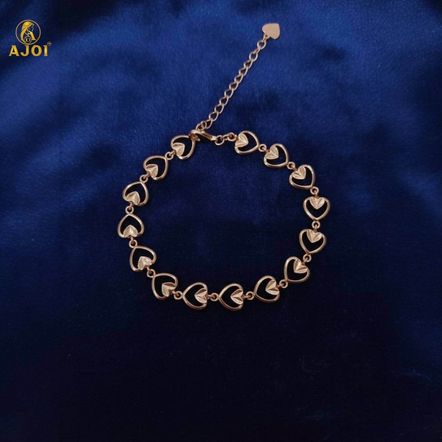 Elegant gold plated heart link bracelet shining under soft light