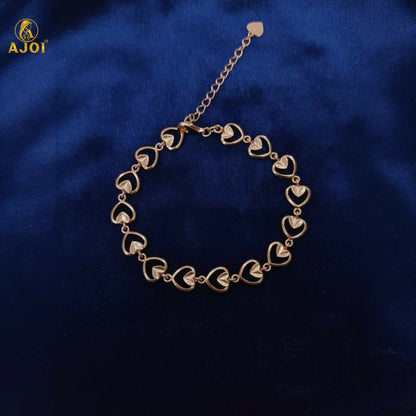Elegant gold plated heart link bracelet shining under soft light