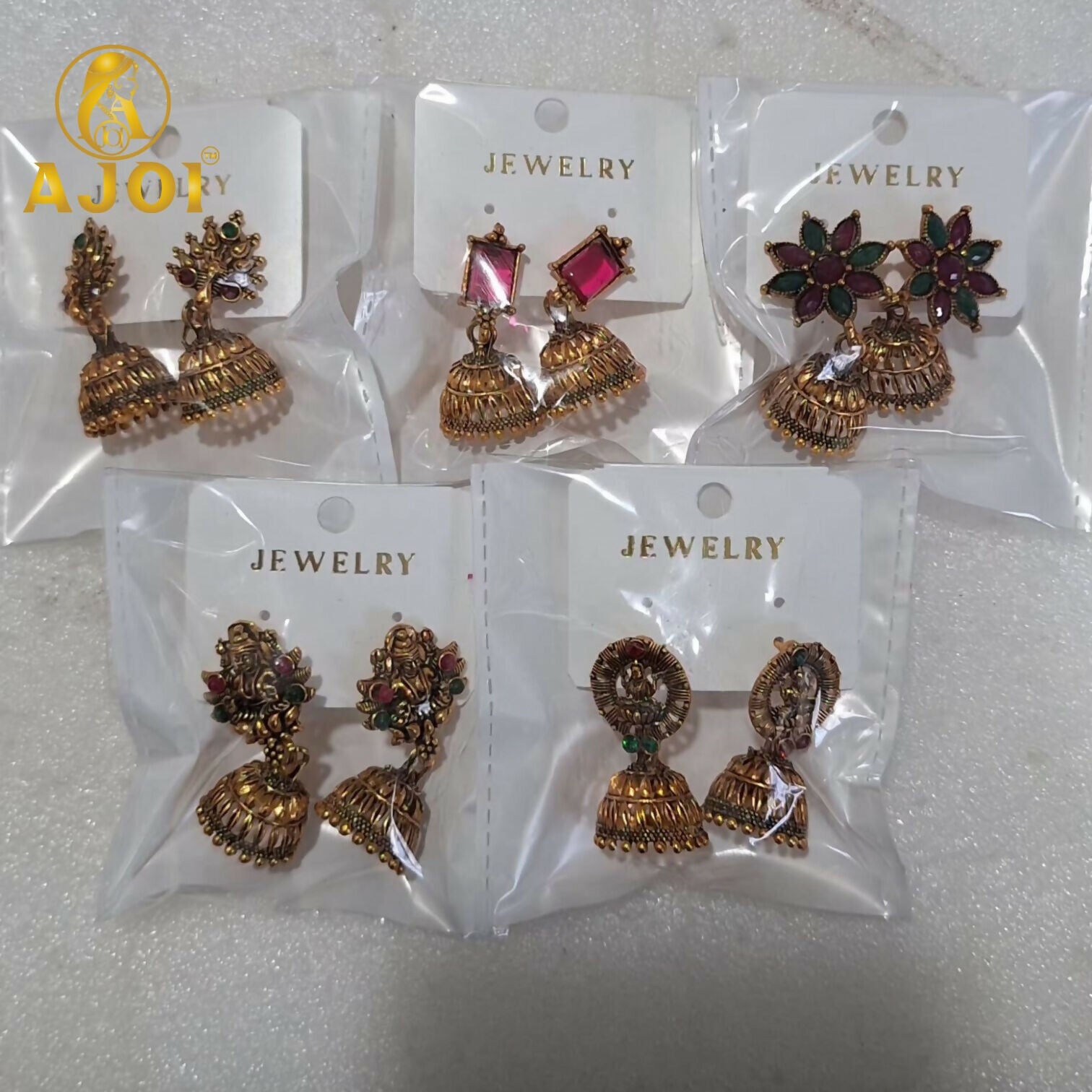 Detailed craftsmanship of temple gold jhumka with stone embellishments