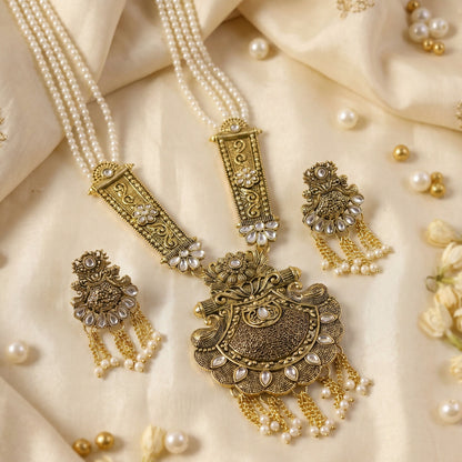 Close-up of pendant detailing on gold and pearl necklace