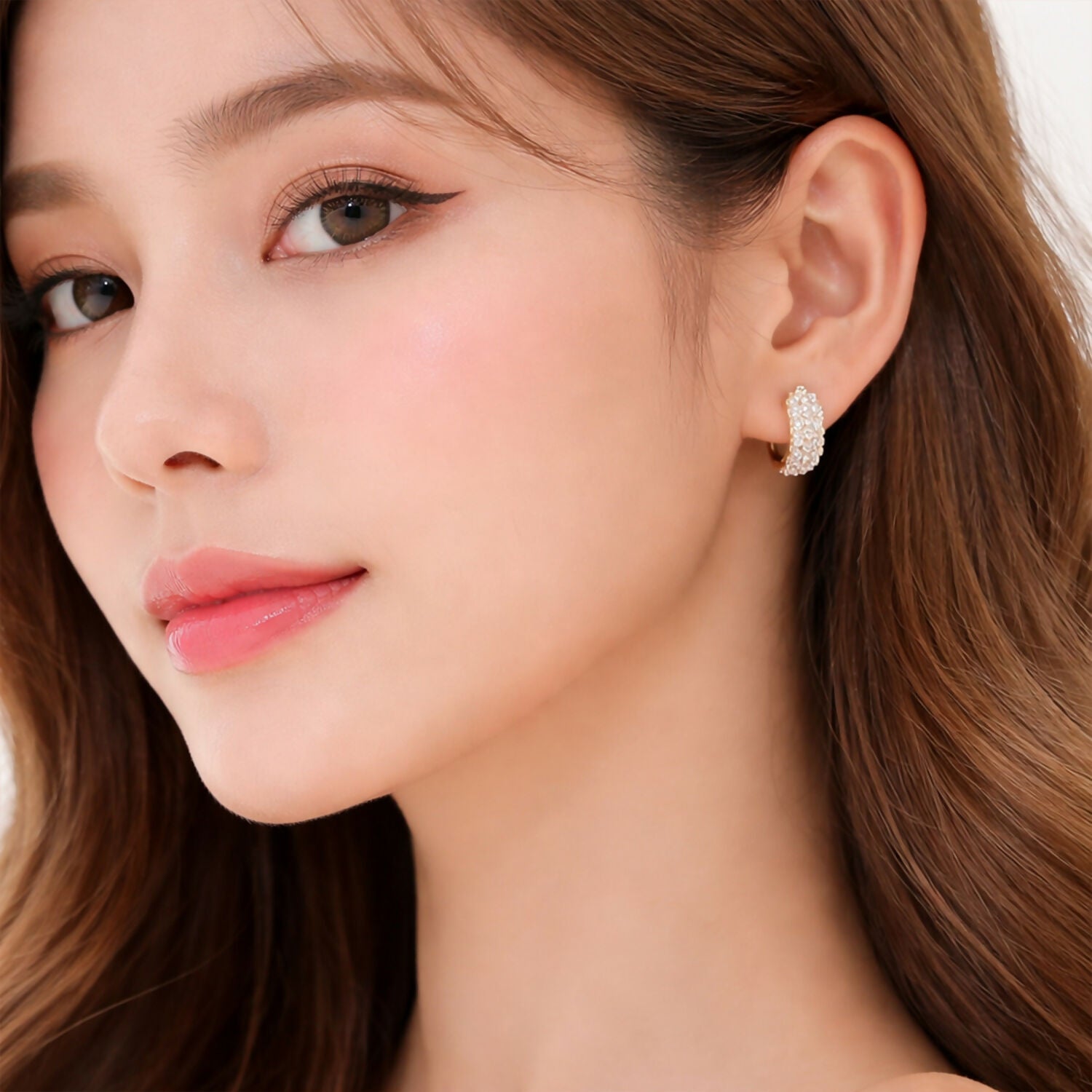Gold textured huggie hoops adorned with brilliant-cut crystals for statement look