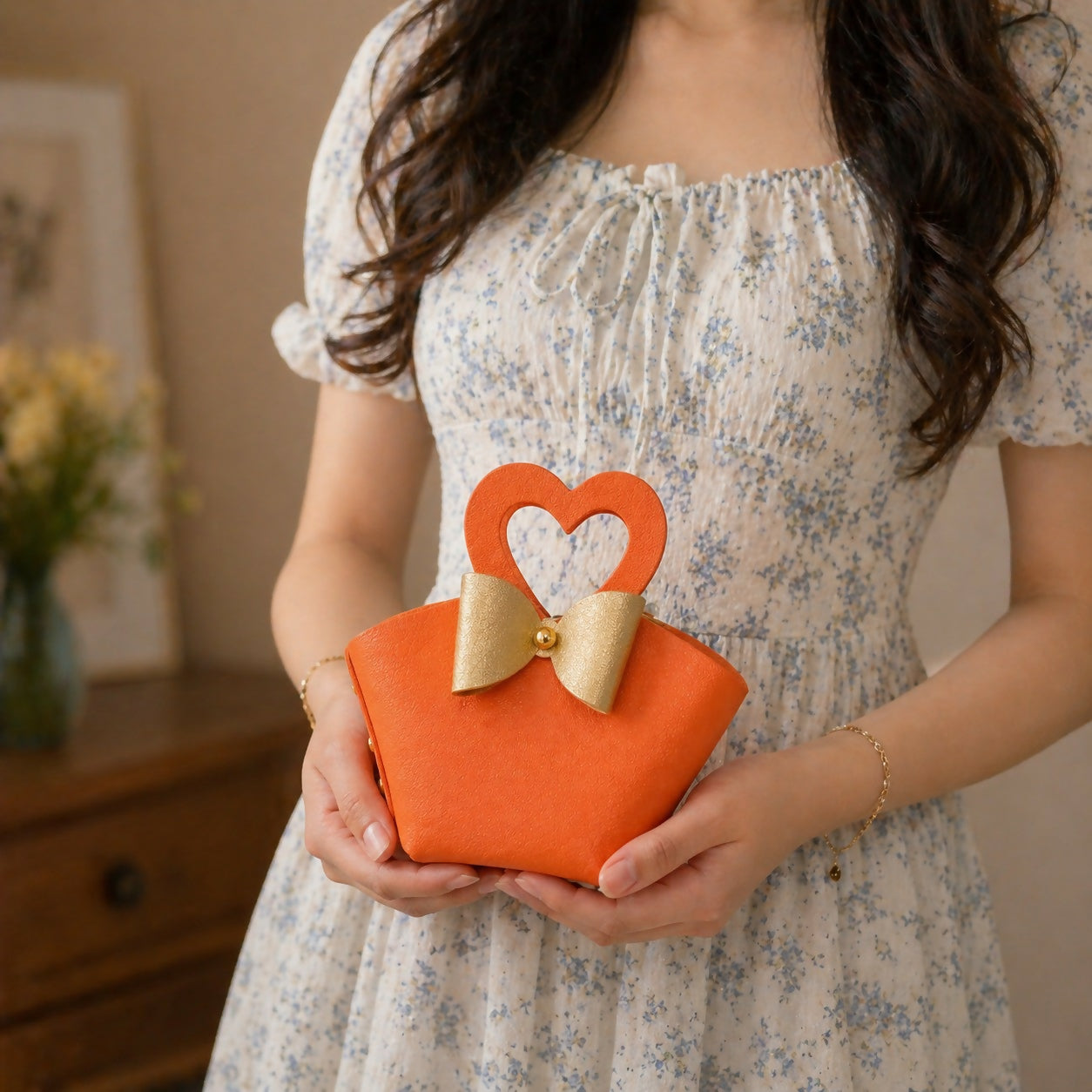 Compact orange mini handbag with elegant bow accent