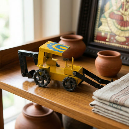 Side view of vintage yellow metal loader tractor miniature