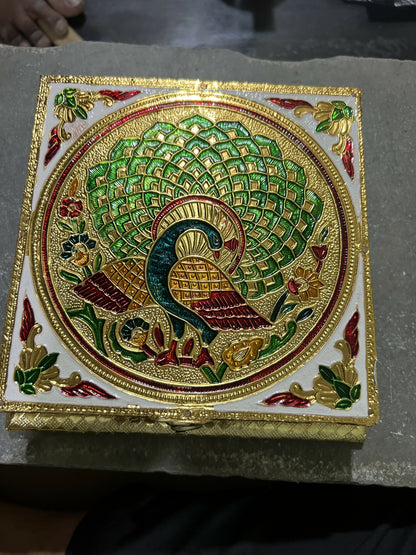 Close-up of intricate floral embossing on golden jewelry box lid