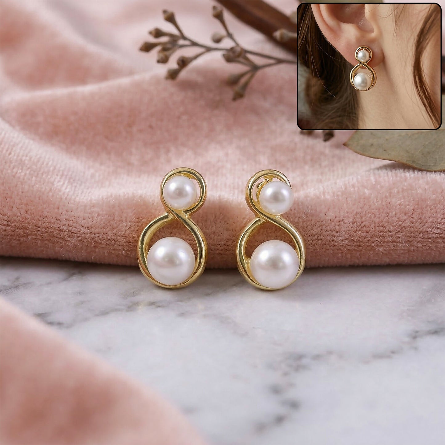 Close-up of Korean pearl infinity stud earrings on white background