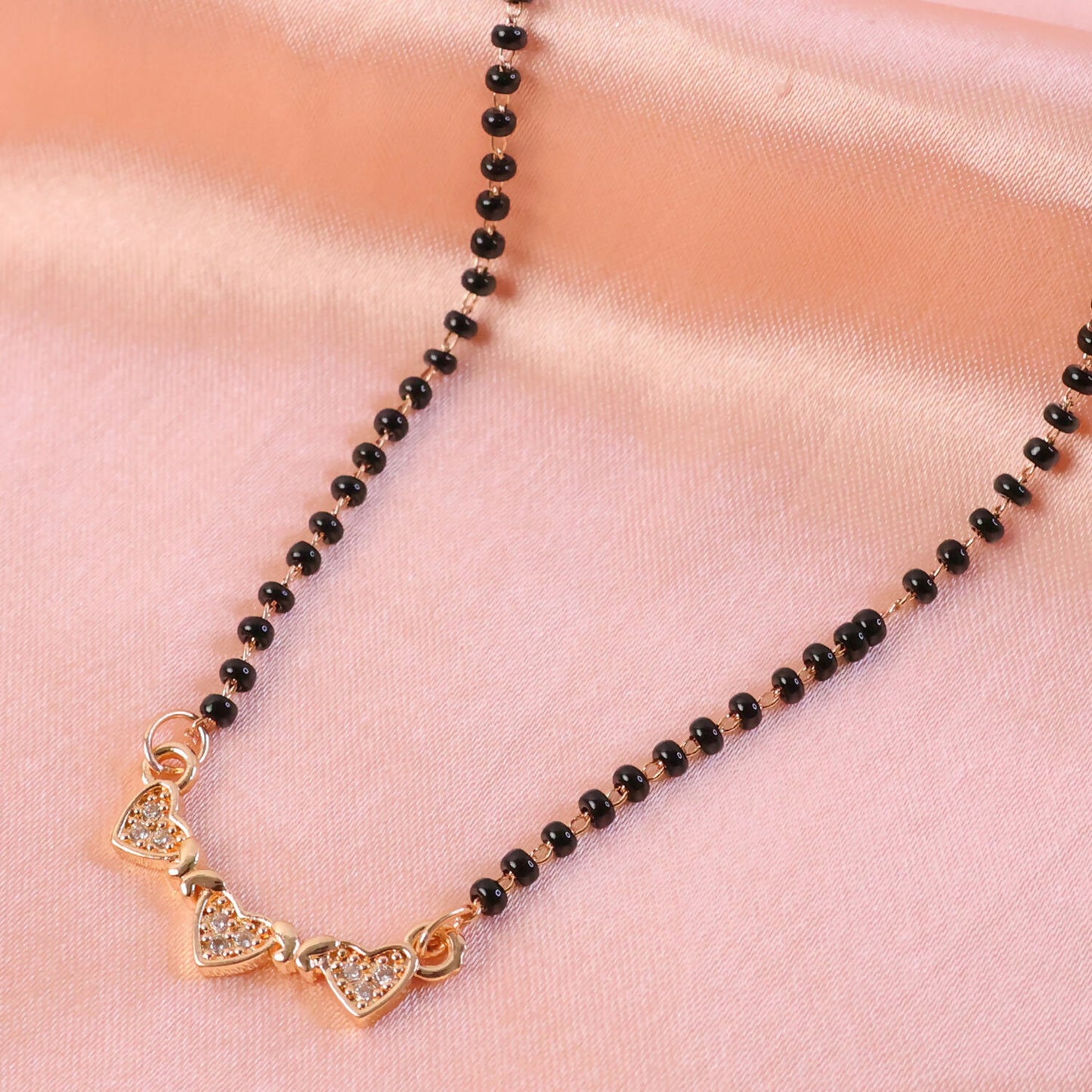 Luxury triple heart mangalsutra necklace worn for special occasions.