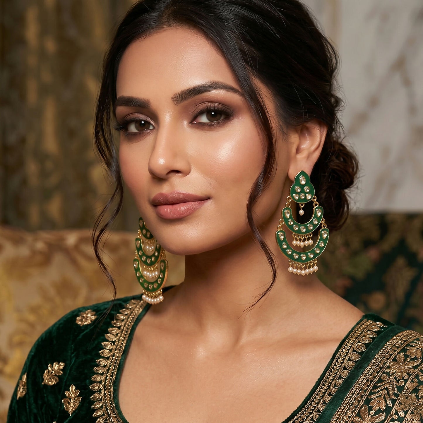 Close-up of golden chain design and stone work on earrings