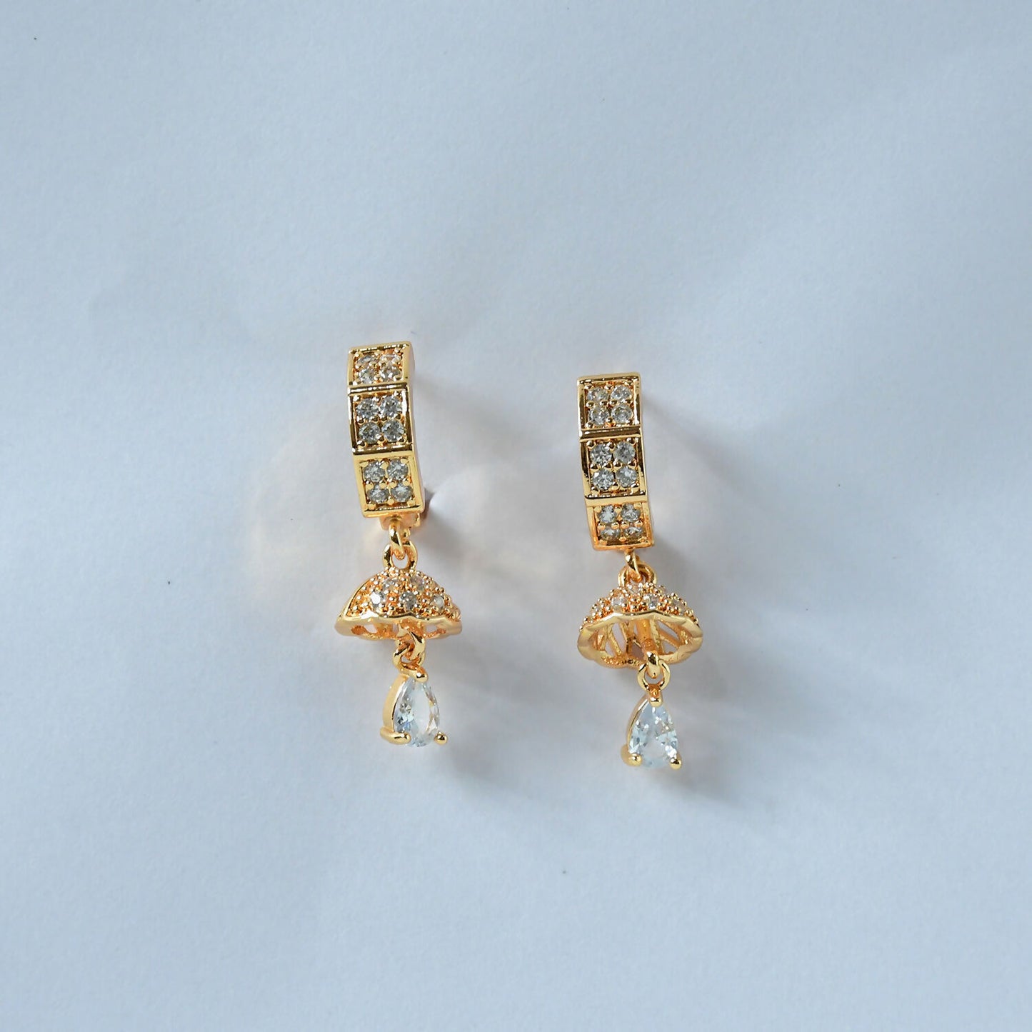 Pair of gold-tone crystal huggie drop earrings styled for festive occasions