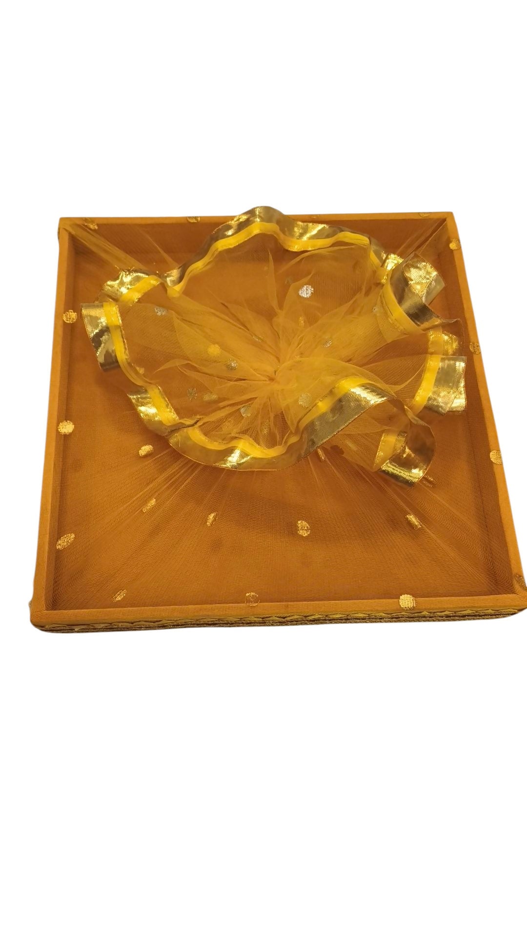 A yellow square tray with ruffled net and gold border, on a plain white background.