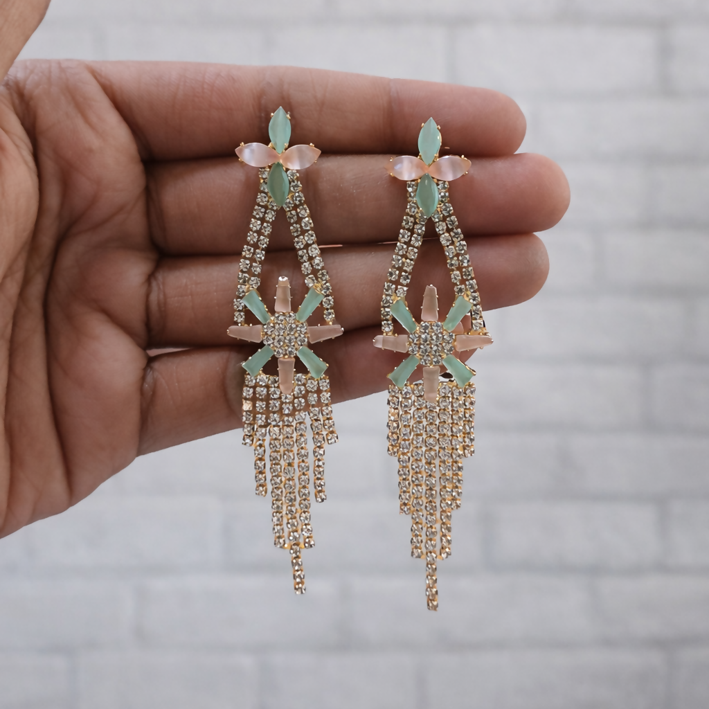 Long cascading rhinestone strands earrings in gold-tone finish