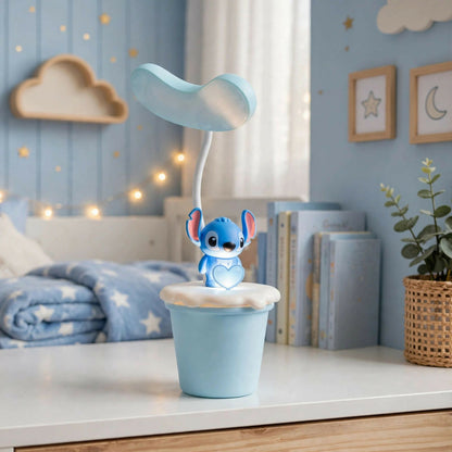 A blue Stitch character desk lamp with a glowing base sits on a white table in a child's bedroom.