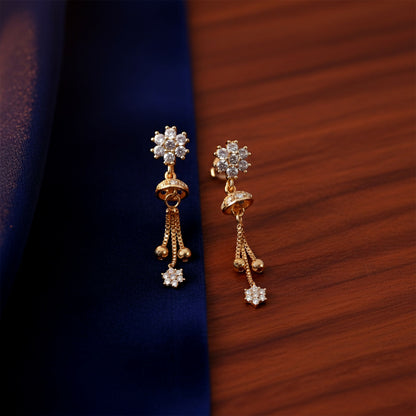 Side angle of gold-tone floral crystal drop earrings showcasing delicate chain tassels and bead accents