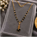 Black Bead Tassel Necklace with Triple Dangle Pendant and Ornamental Link Detailing