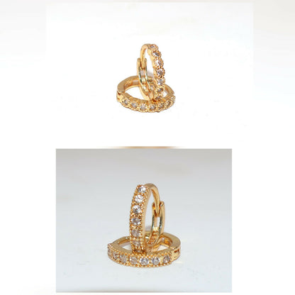Gold plated huggie hoop earrings shown worn, highlighting their comfortable fit and sparkle