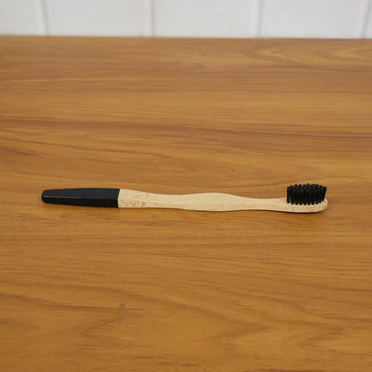 Lifestyle image of bamboo charcoal toothbrush in use