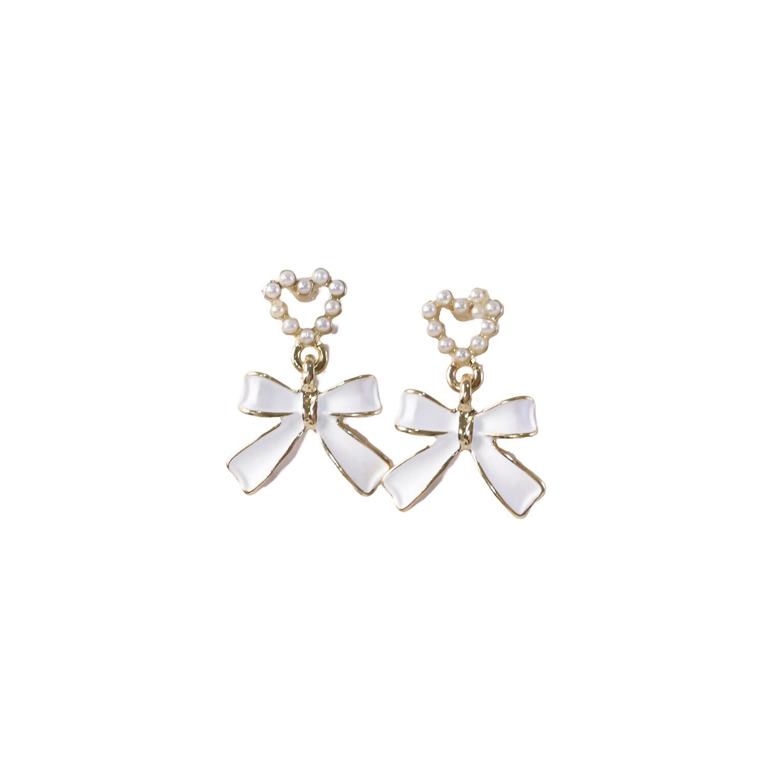 Close-up detailing of gold trim on pearl heart earrings