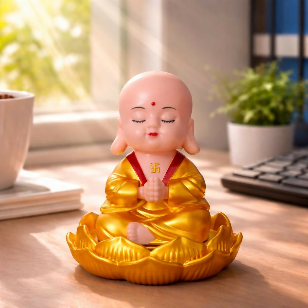 Solar powered monk bobble head on dashboard
