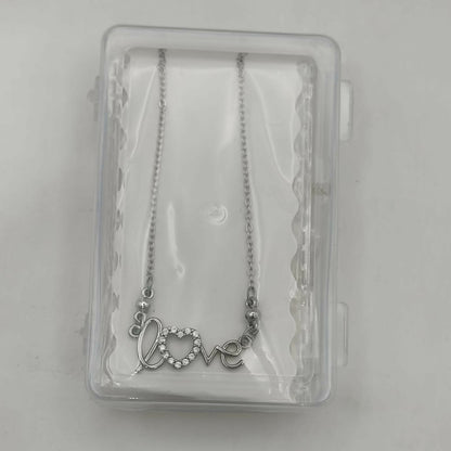 Model wearing silver love script heart pendant necklace with adjustable fine link chain