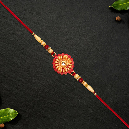 Floral bead rakhi displayed with traditional decorations