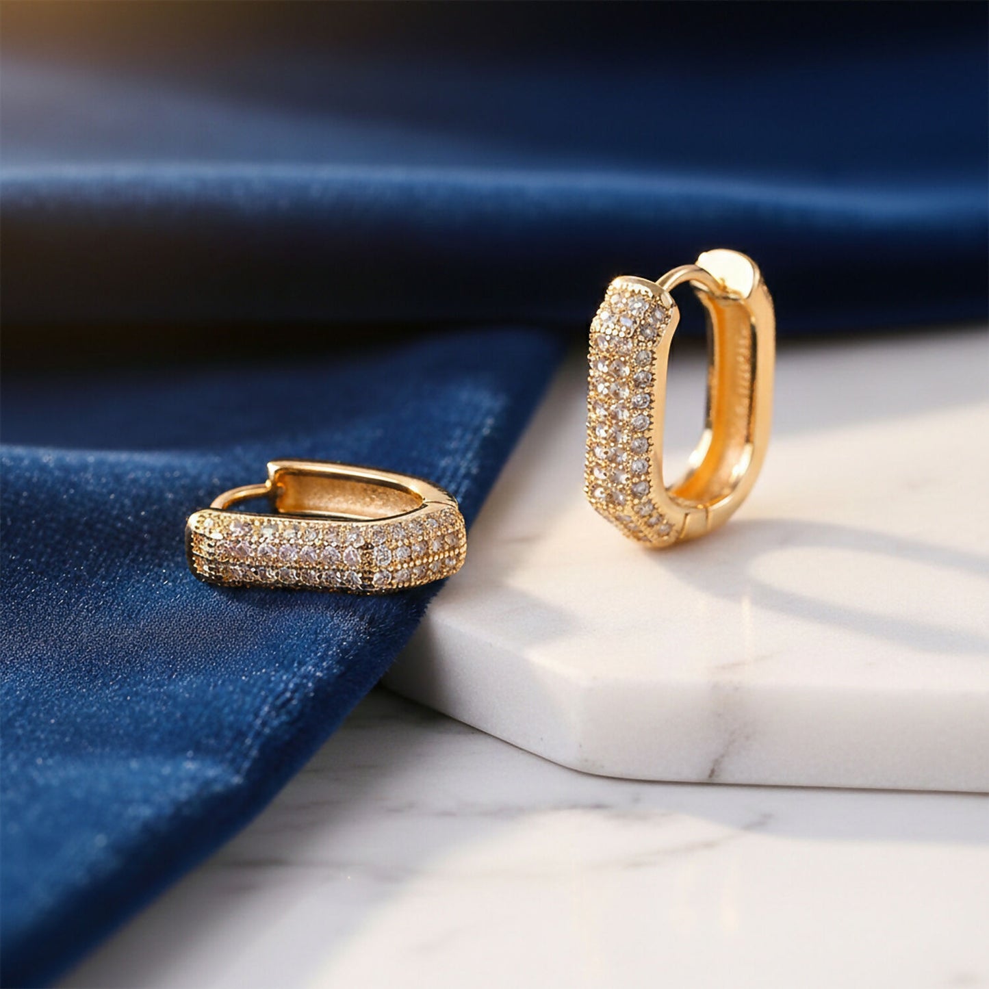 Pair of lightweight gold finish hoop earrings with cubic zirconia stones