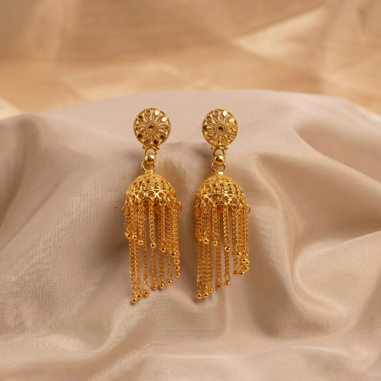 Golden Chain Tassel Jhumka Earrings on white background