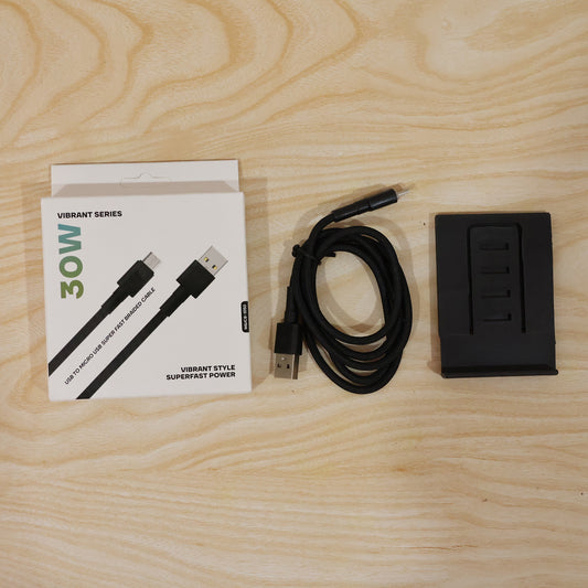 Smartphone charging via 30W Micro USB braided cable with phone stand in use