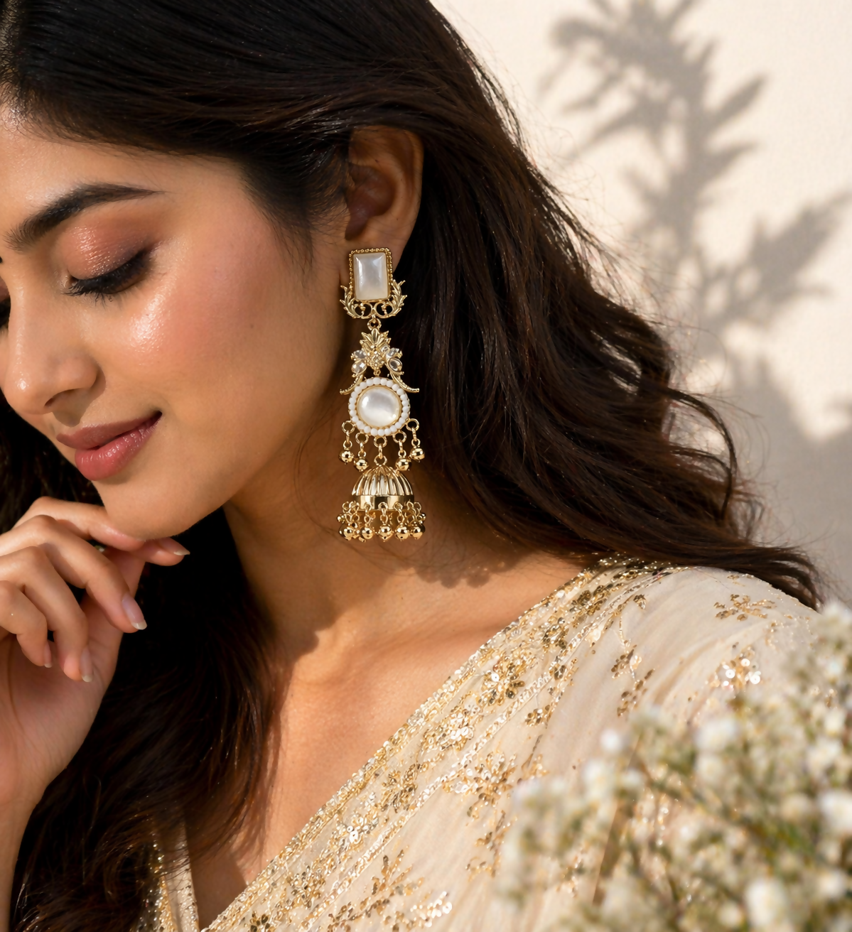 Side view of traditional Kashmiri jhumka earrings with dangling golden drops