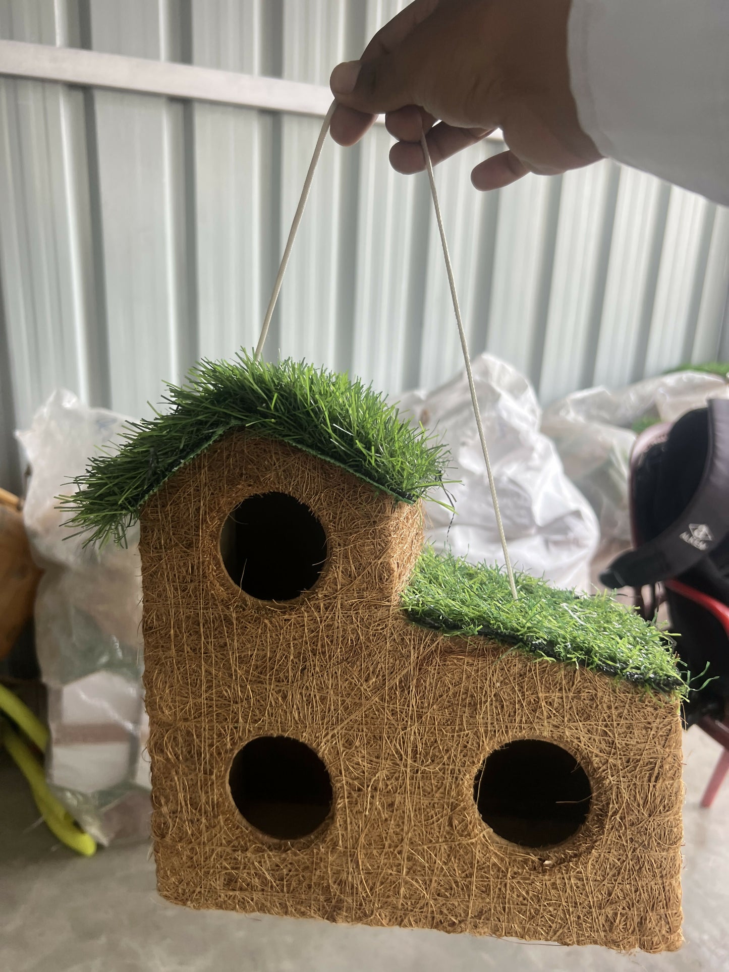 EcoCoir coconut coir bird house hanging in garden setting
