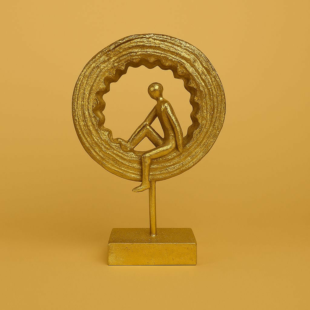 Side view of golden yoga meditation sculpture with circular ring