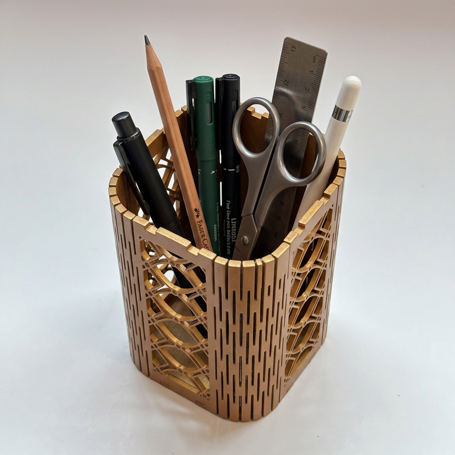 Wooden desk organizer holding pens and pencils, showcasing its spacious cylindrical design